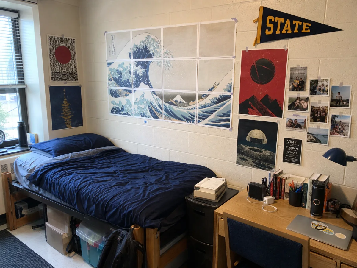 Posters and a college flag displayed in a dorm room
